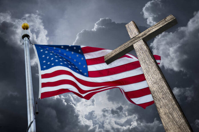 American,Flag,With,A,Christian,Cross,And,Dramatic,Clouds.