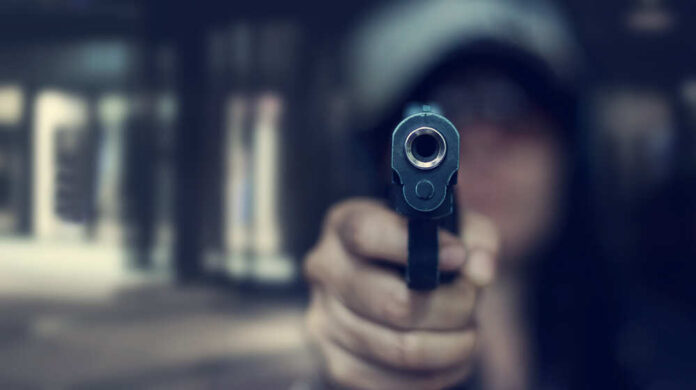 Woman,Pointing,A,Gun,At,The,Target,On,Dark,Background,