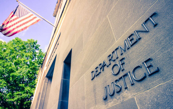 shutterstock_1384089728.jpg featured image Department of Justice building with American flag.