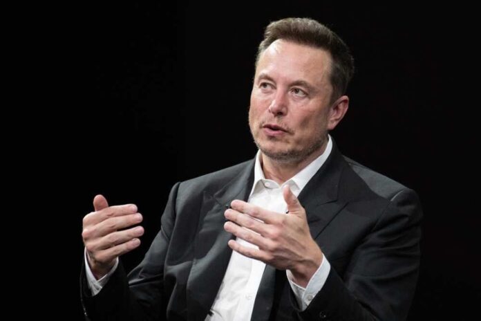 shutterstock_2318800325.jpg featured image Elon Musk speaking and gesturing with hands in discussion.