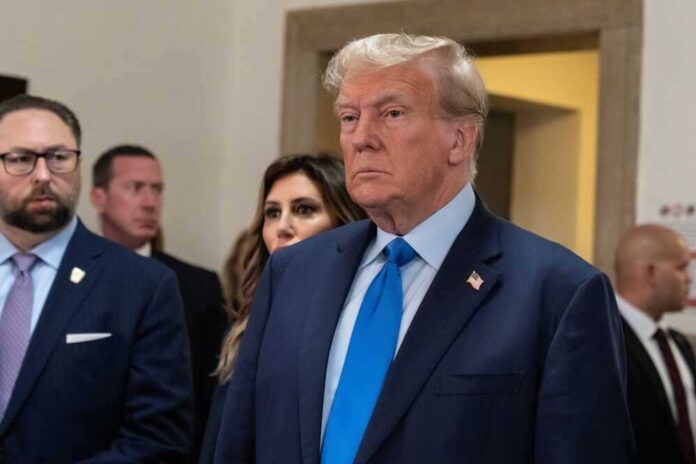 shutterstock_2369816083.jpg featured image Donald Trump in formal attire standing indoors.