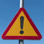 Triangular warning sign with exclamation mark.