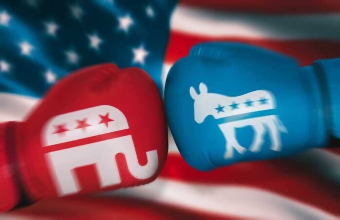 shutterstock_2220552921.jpg featured image Red Republican glove and blue Democrat glove facing off.