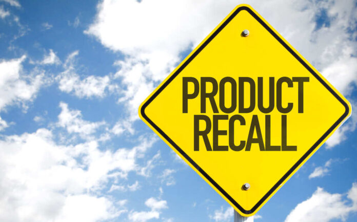 Yellow product recall sign against cloudy sky
