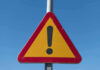 Triangular warning sign with exclamation mark.