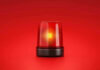 Red emergency light on solid red background.