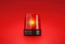 Red emergency light on solid red background.