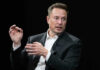 Elon Musk in a suit talking