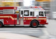 Red fire truck driving on city street
