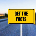 Yellow sign reads Get the Facts on road