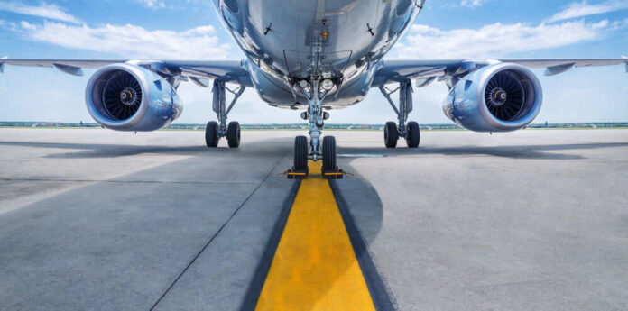 shutterstock_637037008.jpg Airplane on runway with visible landing gear engines