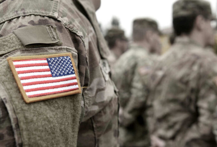 Soldiers in camouflage uniforms with American flag patches
