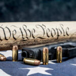 BOOM! Trump Overhauls Gun Permits Gun, bullets, Constitution scroll on American flag