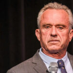 Robert F Kennedy Jr holding microphone