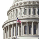 US Capitol dome with American flag flying