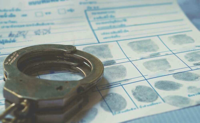 Handcuffs on a fingerprint document.