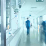 A True Miracle: Medical World Astonished! Hospital corridor with IV drip and healthcare worker