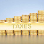 Bombshell Tax Announcement by IRS During Government Meltdown Stacked coins with TAXES on block beneath
