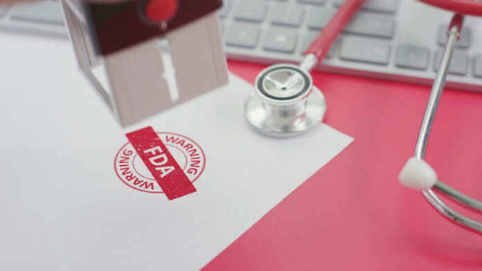 FDA warning stamp near stethoscope and keyboard