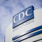 CDC building sign against a cloudy sky