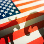 Donkey and elephant shadows on American flag background