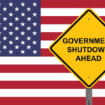 Government Shutdown Causing Travel Nightmare American flag government shutdown warning sign