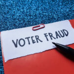 Multiple Ballot Scam EXPOSED — Voter FRAUD! Paperclip holding paper labeled voter fraud marker
