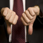 Overwhelming Support IGNORED By Washington Bureaucrats Two hands showing thumbs down in a suit