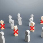 Retailers SLASH Holiday Jobs Despite Record Profits Wooden figures with red X marks, signifying eliminated individuals.