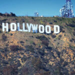 Just-Released Movie’s Record-Breaking Run Stuns Hollywood Hollywood sign on hillside with communication towers.