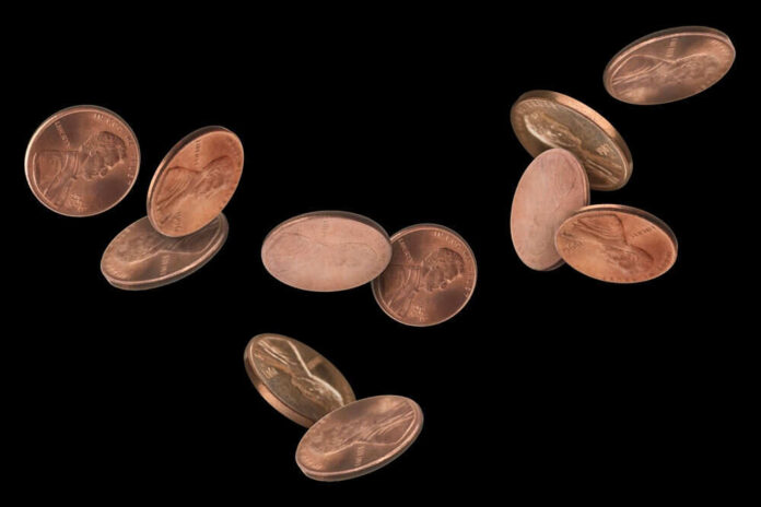Floating copper coins against a black background