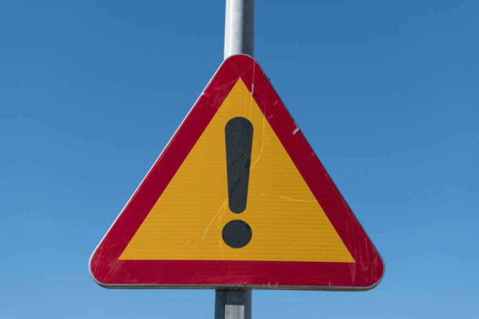Triangular warning sign with exclamation mark.