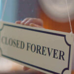 Closed forever sign being placed on window.