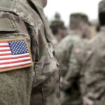 $900 Billion Military Shake-Up Stuns Democrats Soldiers in camouflage uniforms with American flag patches.