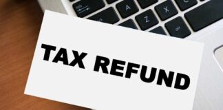 A card displaying the words 'TAX REFUND' placed on a laptop keyboard