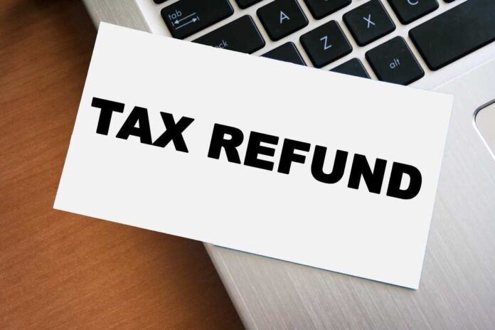 A card displaying the words 'TAX REFUND' placed on a laptop keyboard