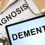 Former Senator’s Dementia Announcement Shocks Colleagues Medical diagnosis paperwork and a tablet displaying the word Dementia