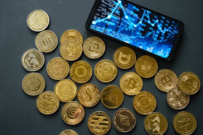 Various cryptocurrency coins scattered around a smartphone displaying market data