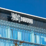 Shocking Toxin Alert: Nestlé Pulls Infant Formula Glass building with Nestle logo and blue sky