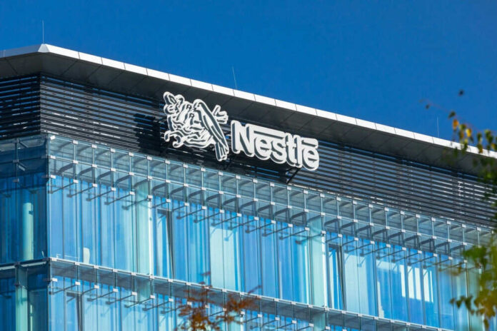 Glass building with Nestle logo and blue sky
