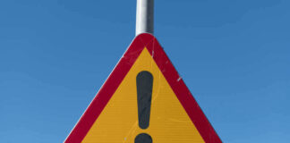 Triangular warning sign with exclamation mark.