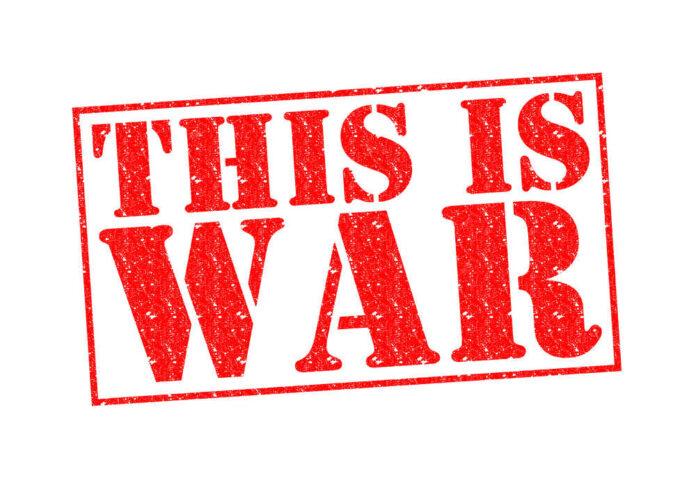 A bold red stamp with the text 'THIS IS WAR'