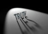 Truth casting shadow spelling Lies on curved surface.