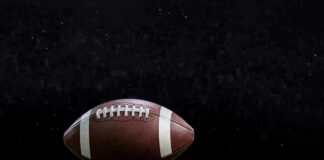 Close-up of a football on a grassy field.