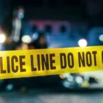 Deadly University Attack: PLOT Spanned Years! Police line caution tape at a crime scene with blurred figures in the background