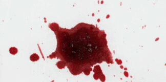 Red liquid splatter on a white background.