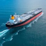 An oil tanker navigating through calm ocean waters