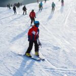 Skiers on a snowy slope at a ski resort