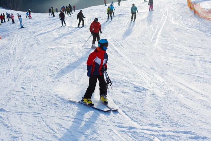 Skiers on a snowy slope at a ski resort