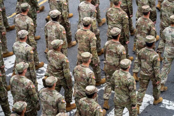 A formation of soldiers in military uniforms marching in a parade